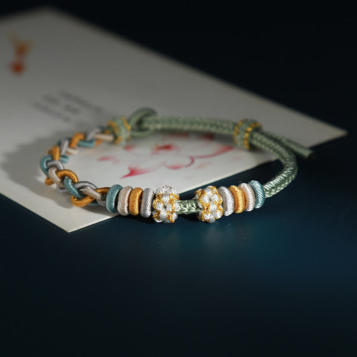 Bracelet de connexion en fleur de pêcher avec quatre Buddha Stones