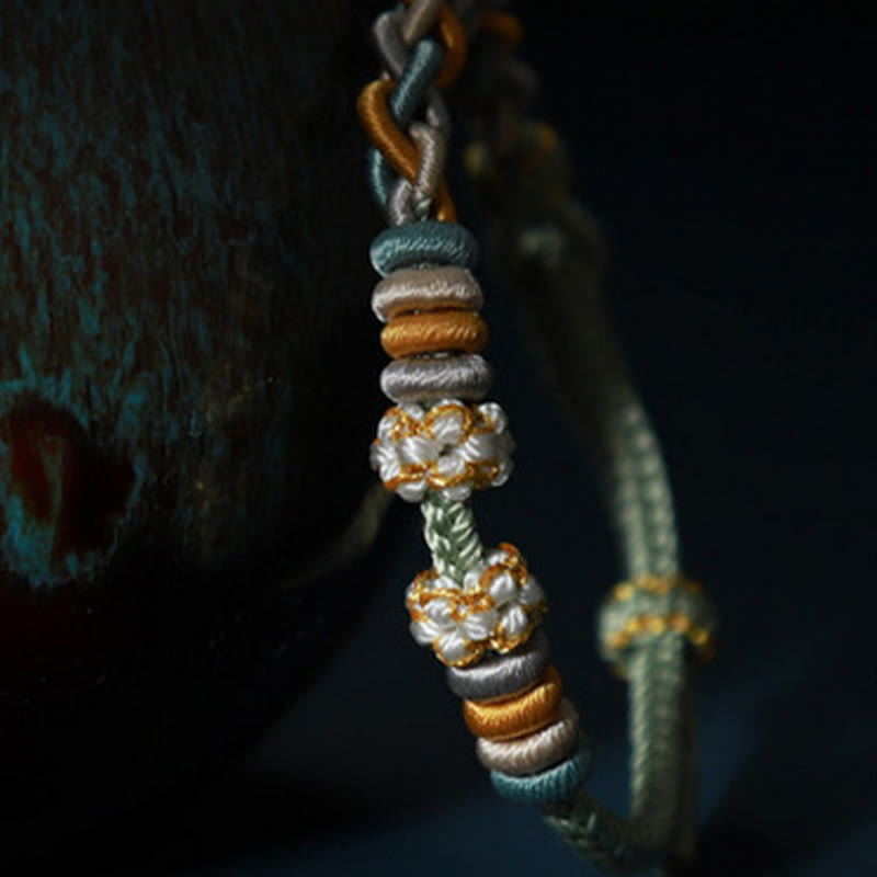 Bracelet de connexion en fleur de pêcher avec quatre Buddha Stones