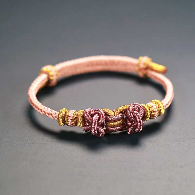 Bracelet de force en corde rouge avec nœud de selle et Buddha Stones