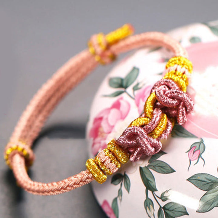 Bracelet de force en corde rouge avec nœud de selle et Buddha Stones