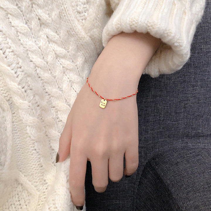 Bracelet porte-bonheur en cuivre plaqué or avec cordon rouge et Buddha Stones