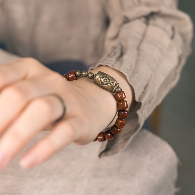 Bracelet de force avec pendentif en forme de cône en cuivre en forme de Dzi en Buddha Stones