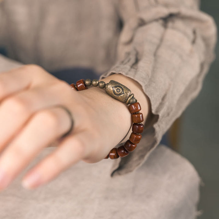 Bracelet de force avec pendentif en forme de cône en cuivre en forme de Dzi en Buddha Stones