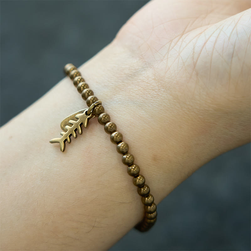 Bracelet de guérison en arête de poisson en cuivre et Buddha Stones