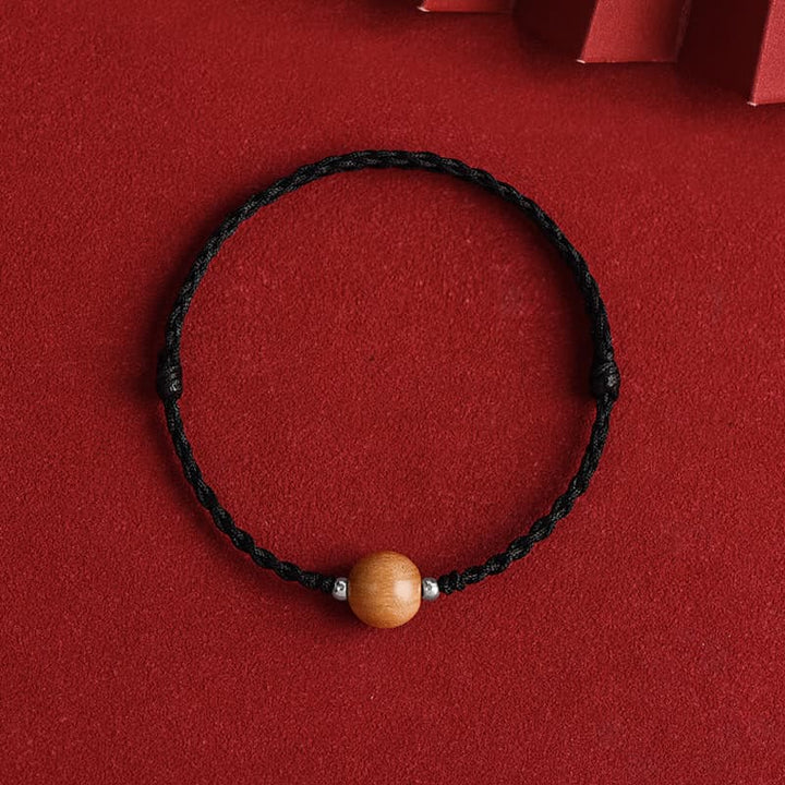 Bracelet de cheville tressé en perles de bois de pêcher naturelles de Buddha Stones
