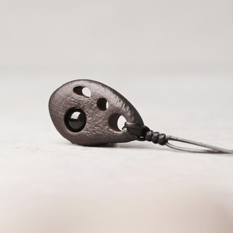 Collier pendentif en obsidienne creuse avec Buddha Stones en bois d'ébène et incrustations de paix et de calme