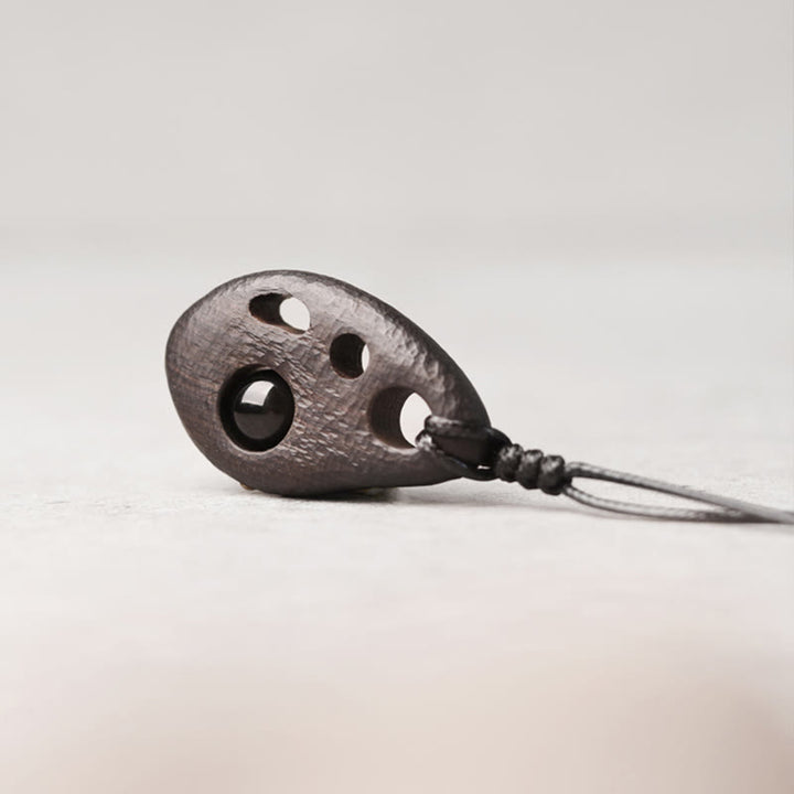 Collier pendentif en obsidienne creuse avec Buddha Stones en bois d'ébène et incrustations de paix et de calme