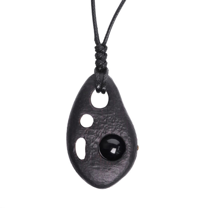 Collier pendentif en obsidienne creuse avec Buddha Stones en bois d'ébène et incrustations de paix et de calme