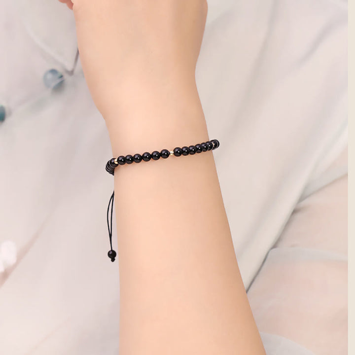 Bracelet en corde avec petites perles d'obsidienne noire Buddha Stones