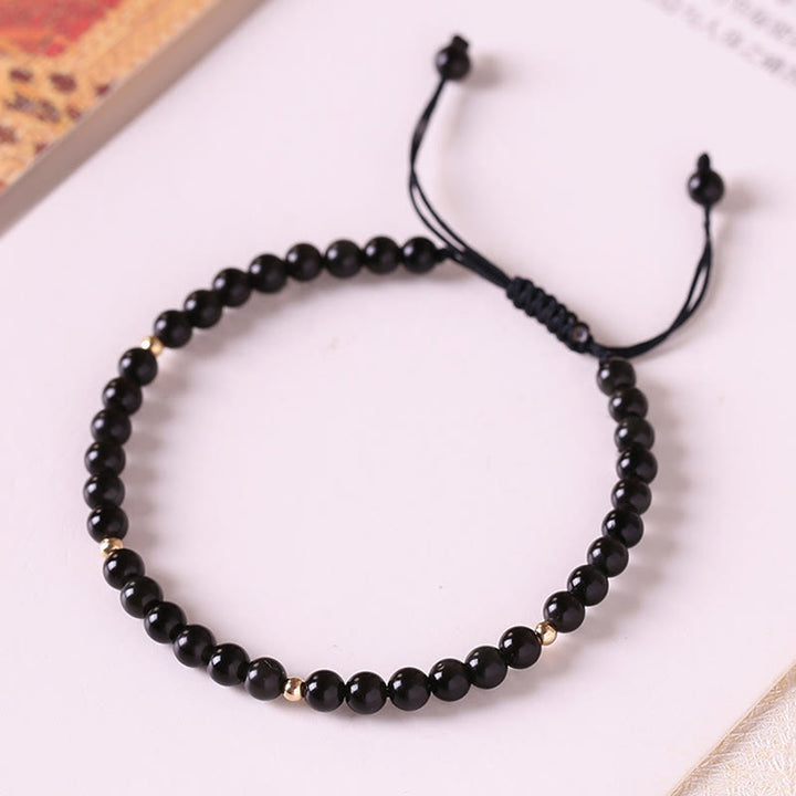 Bracelet en corde avec petites perles d'obsidienne noire Buddha Stones