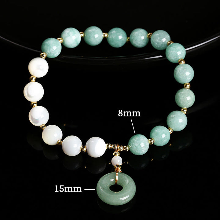 Bracelet d'abondance avec breloque en forme de boucle de paix , Buddha Stones , jade, trochus, fer à cheval, escargot