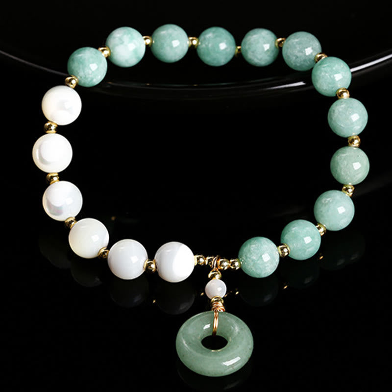 Bracelet d'abondance avec breloque en forme de boucle de paix , Buddha Stones , jade, trochus, fer à cheval, escargot