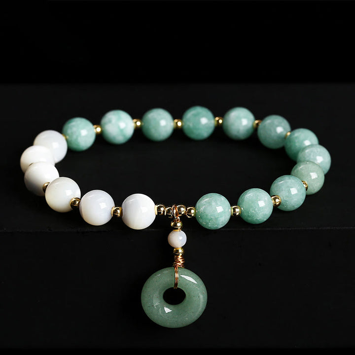 Bracelet d'abondance avec breloque en forme de boucle de paix , Buddha Stones , jade, trochus, fer à cheval, escargot