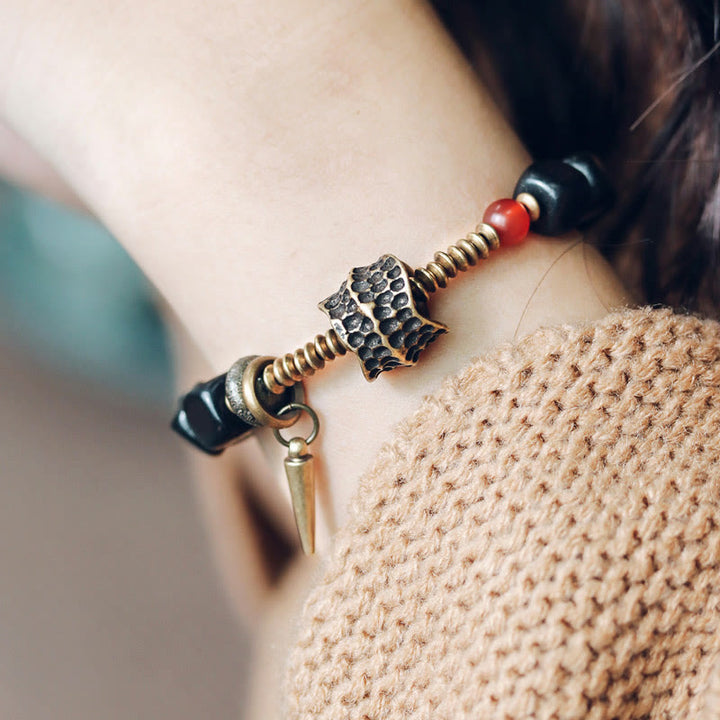 Bracelet de paix en Buddha Stones, bois d'ébène, cuivre, laiton, agate rouge