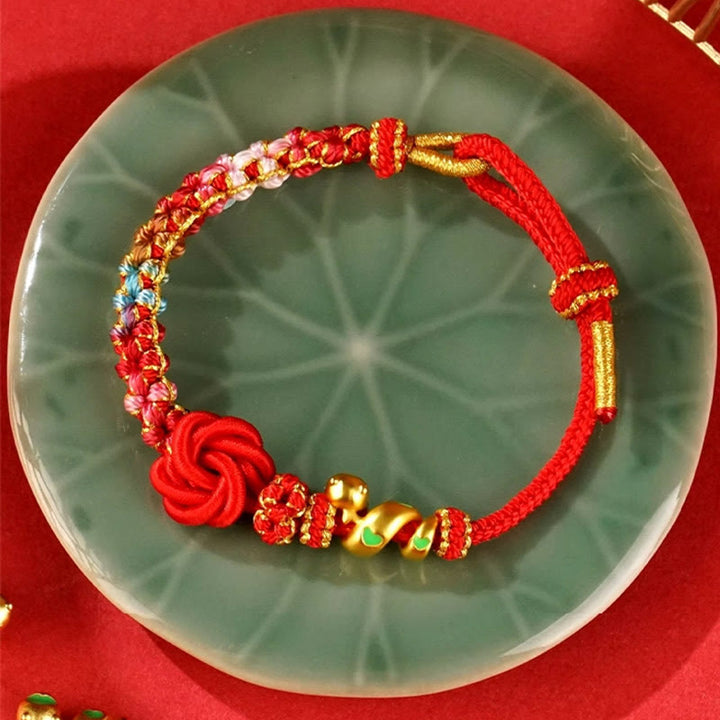 Bracelet tressé de protection de l'année du serpent avec Buddha Stones mandala en fil rouge tissé à la main avec fleurs colorées