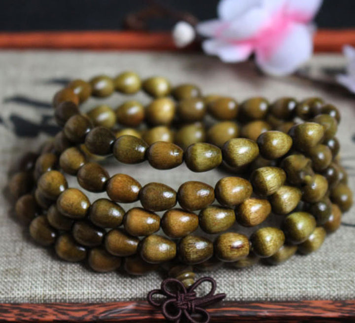 Bracelet de protection en bois naturel Phoebe Zhennan avec 108 perles en forme de larme de Mala Buddha Stones