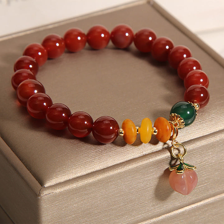 Bracelet d'acceptation de soi avec breloque pêche et agate rouge de Buddha Stones