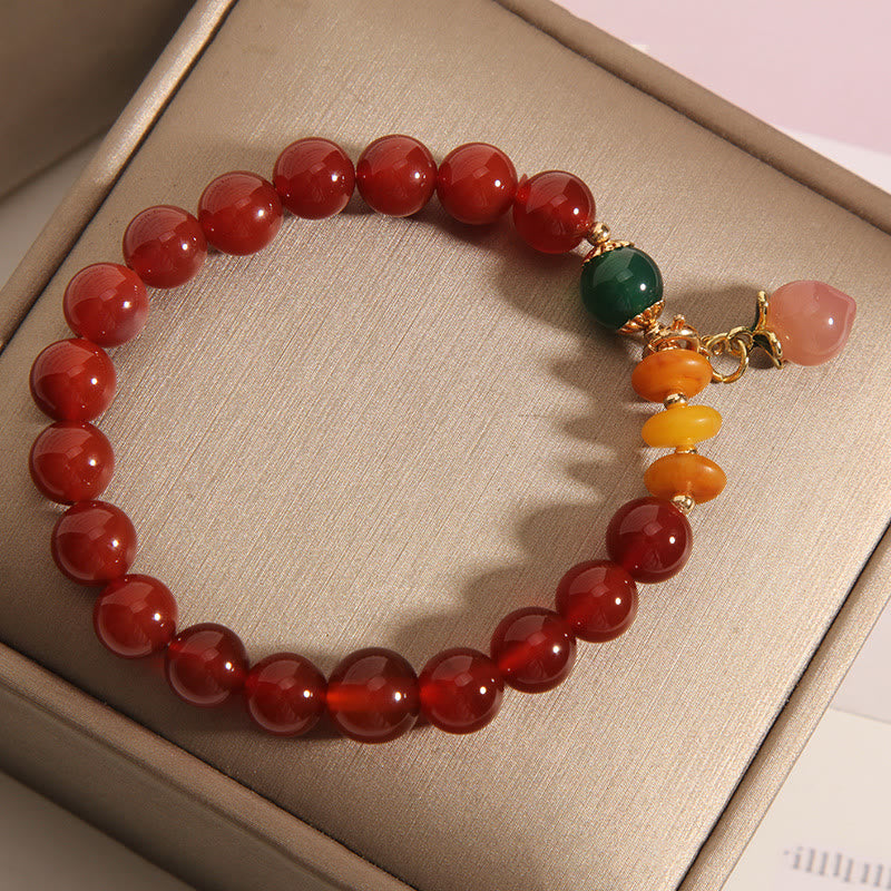 Bracelet d'acceptation de soi avec breloque pêche et agate rouge de Buddha Stones