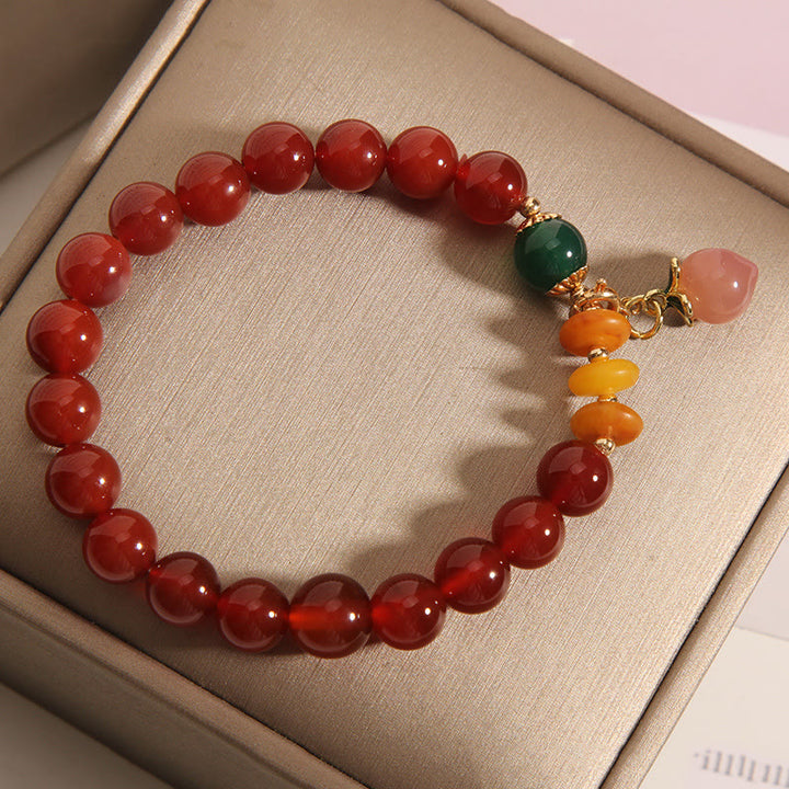 Bracelet d'acceptation de soi avec breloque pêche et agate rouge de Buddha Stones