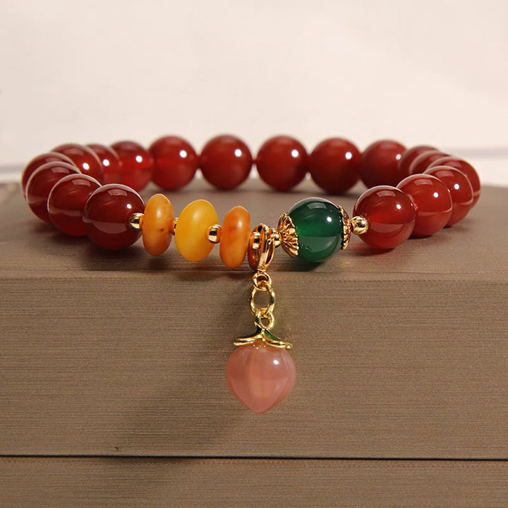 Bracelet d'acceptation de soi avec breloque pêche et agate rouge de Buddha Stones