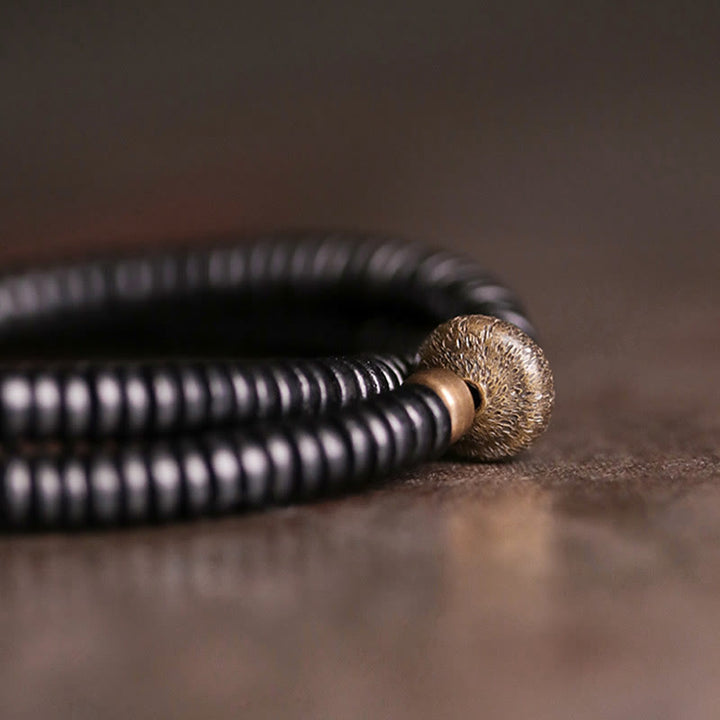 Bracelet double tour en bois d'ébène et cuivre avec Buddha Stones