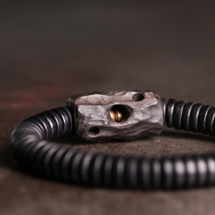 Bracelet d'équilibre troué en bois d'ébène et cuivre et laiton avec Buddha Stones
