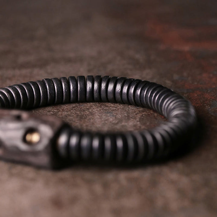 Bracelet d'équilibre troué en bois d'ébène et cuivre et laiton avec Buddha Stones