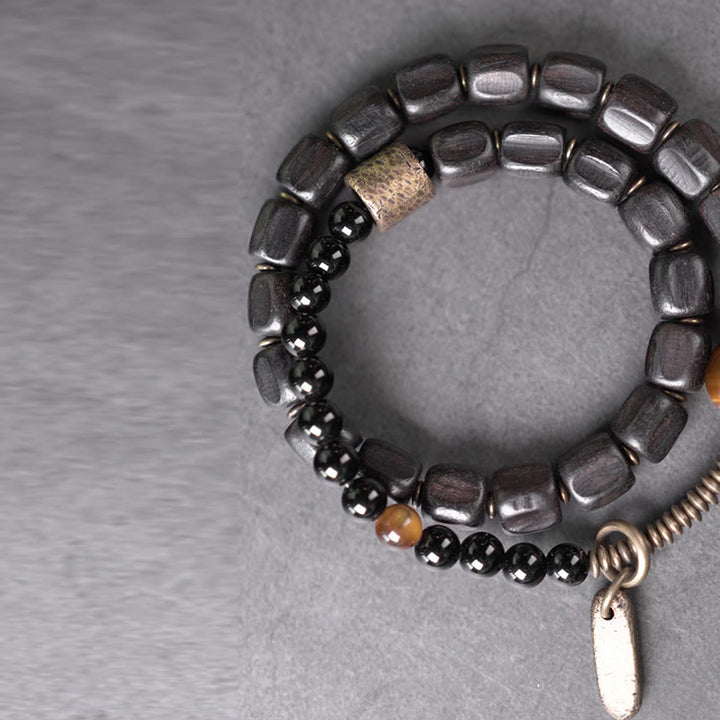 Bracelet double tour en Buddha Stones, bois d'ébène, cuivre, laiton, œil de tigre, paix