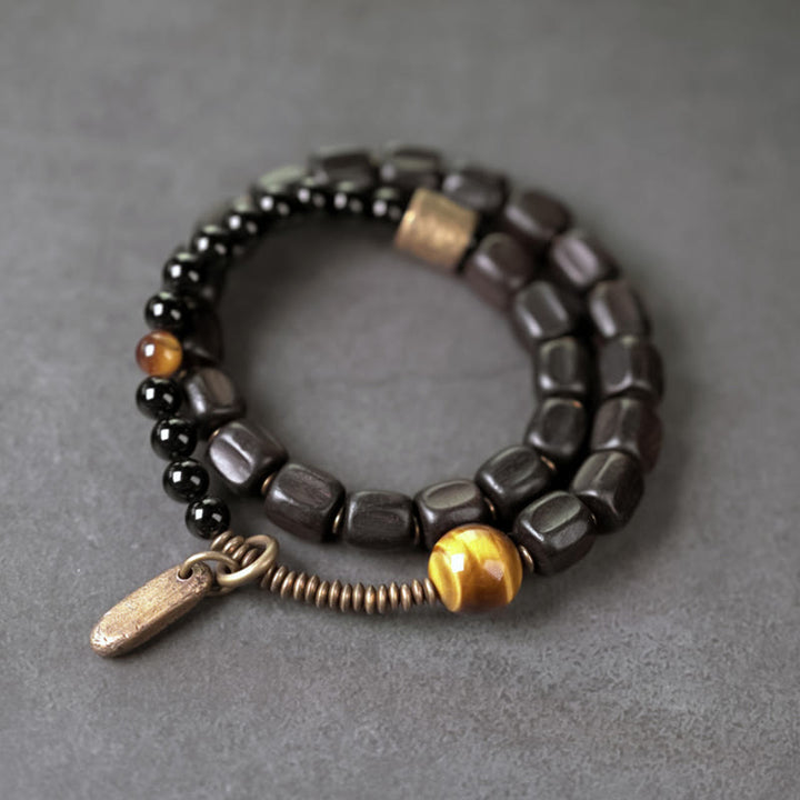 Bracelet double tour en Buddha Stones, bois d'ébène, cuivre, laiton, œil de tigre, paix