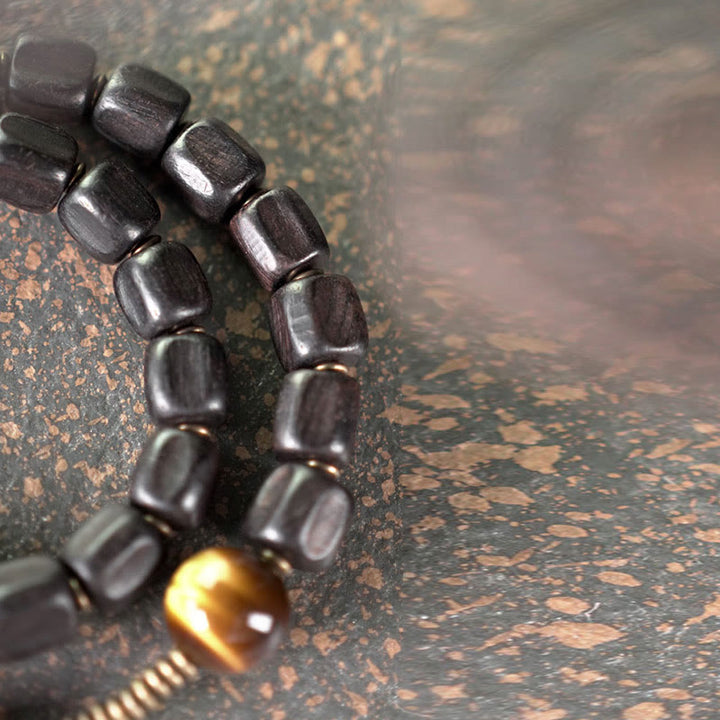 Bracelet double tour en Buddha Stones, bois d'ébène, cuivre, laiton, œil de tigre, paix