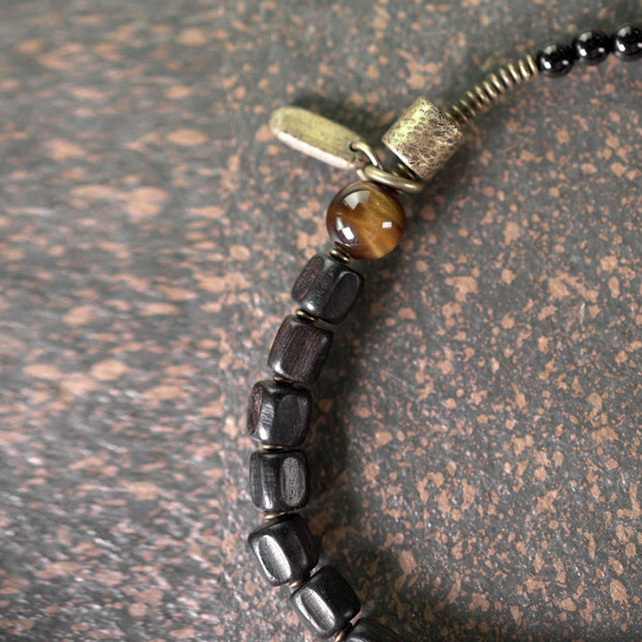 Bracelet double tour en Buddha Stones, bois d'ébène, cuivre, laiton, œil de tigre, paix