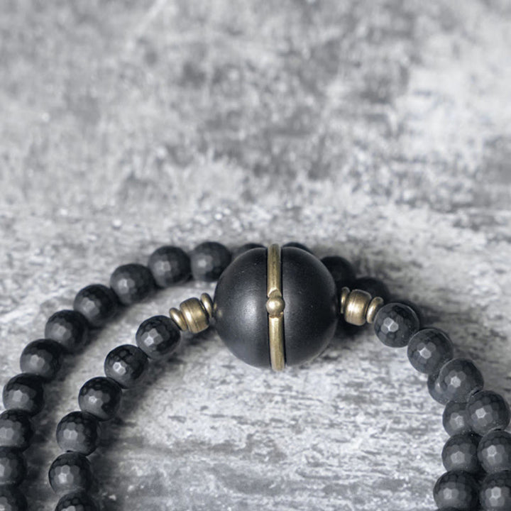 Bracelet de protection à double tour en perles d'ébène et d'onyx noir avec surface coupée givrée et Buddha Stones