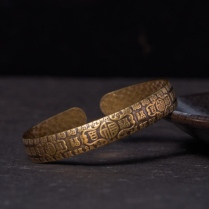 Bracelet porte-bonheur en cuivre et laiton avec personnages de Buddha Stones et cent bénédictions