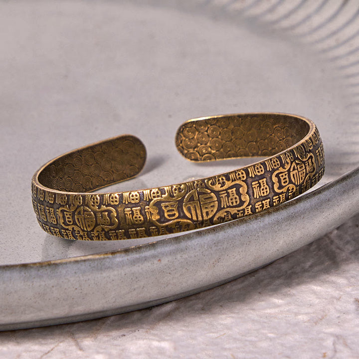 Bracelet porte-bonheur en cuivre et laiton avec personnages de Buddha Stones et cent bénédictions