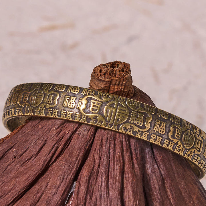 Bracelet porte-bonheur en cuivre et laiton avec personnages de Buddha Stones et cent bénédictions