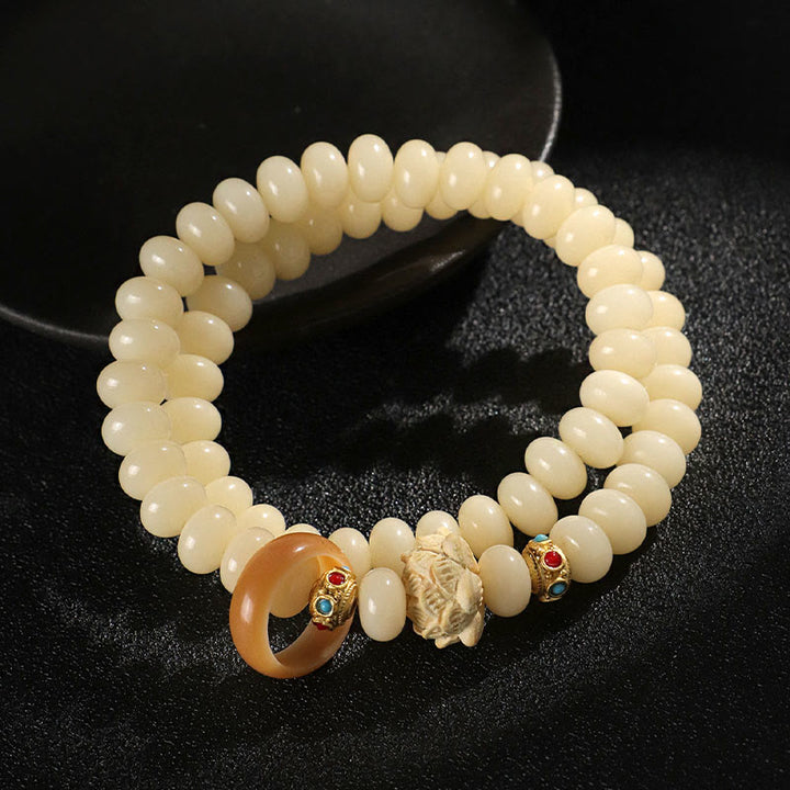 Bracelet double tour en bois de pêche et graines de Bodhi Buddha Stones et lotus