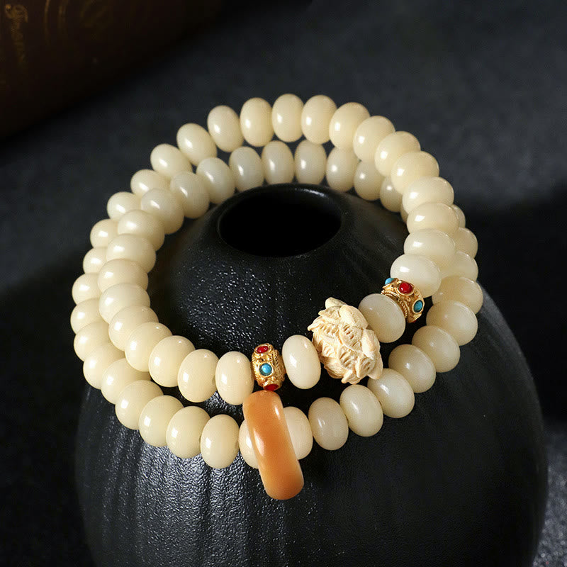 Bracelet double tour en bois de pêche et graines de Bodhi Buddha Stones et lotus