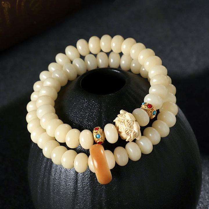 Bracelet double tour en bois de pêche et graines de Bodhi Buddha Stones et lotus