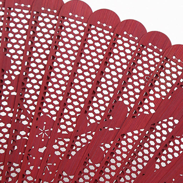 Éventail pliable en bambou à gravure creuse rétro avec Buddha Stones