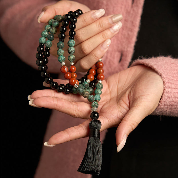 Bracelet de protection à pompon en Buddha Stones 108 Mala en onyx noir naturel et jaspe rouge avec perles turquoise