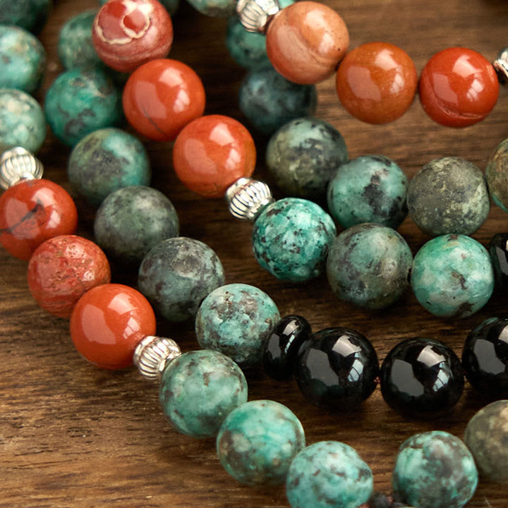 Bracelet de protection à pompon en Buddha Stones 108 Mala en onyx noir naturel et jaspe rouge avec perles turquoise