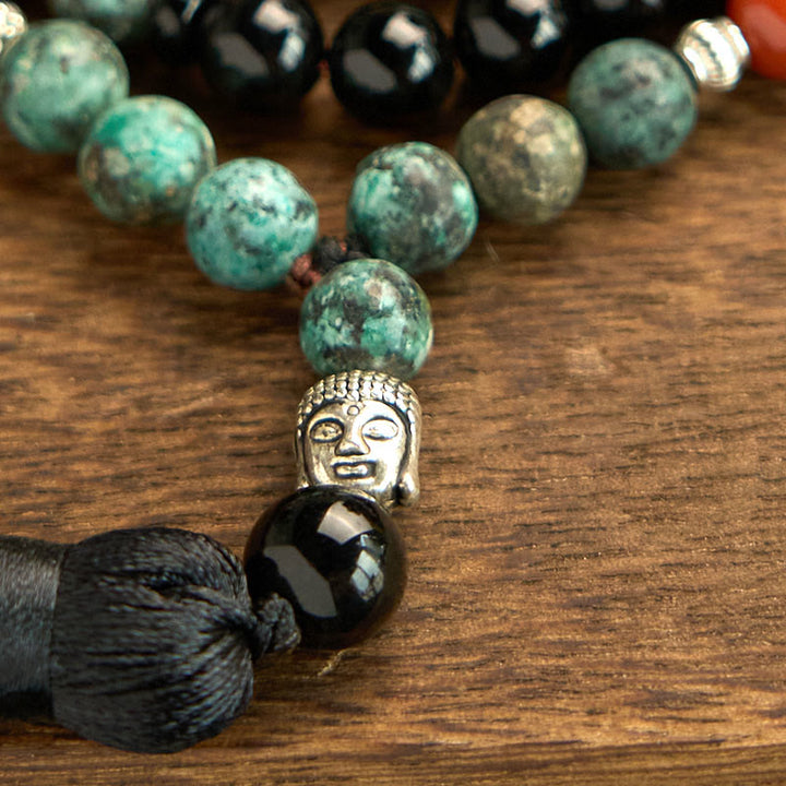 Bracelet de protection à pompon en Buddha Stones 108 Mala en onyx noir naturel et jaspe rouge avec perles turquoise
