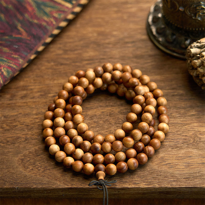 Bracelet de protection poli à la main en bois de pêche avec 108 perles de Mala en Buddha Stones