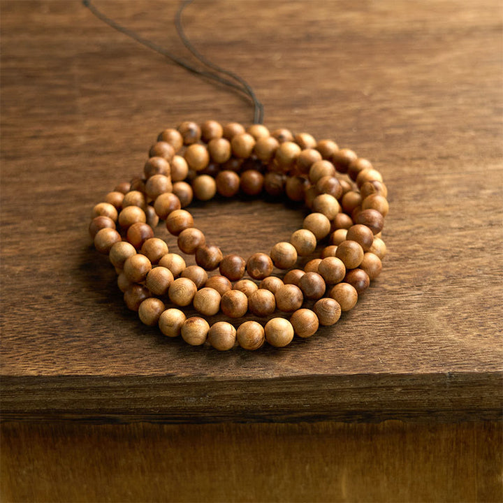 Bracelet de protection poli à la main en bois de pêche avec 108 perles de Mala en Buddha Stones