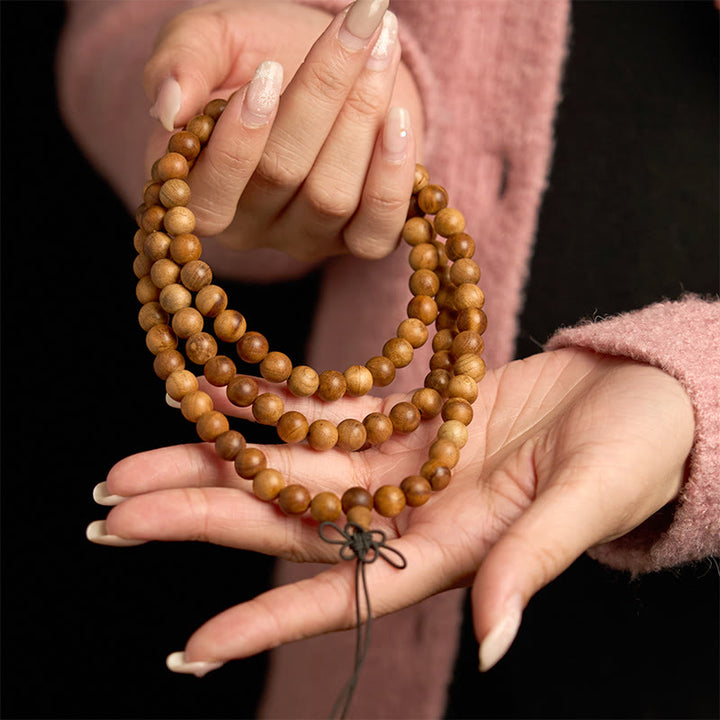 Bracelet de protection poli à la main en bois de pêche avec 108 perles de Mala en Buddha Stones