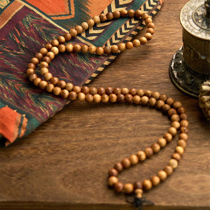 Bracelet de protection poli à la main en bois de pêche avec 108 perles de Mala en Buddha Stones