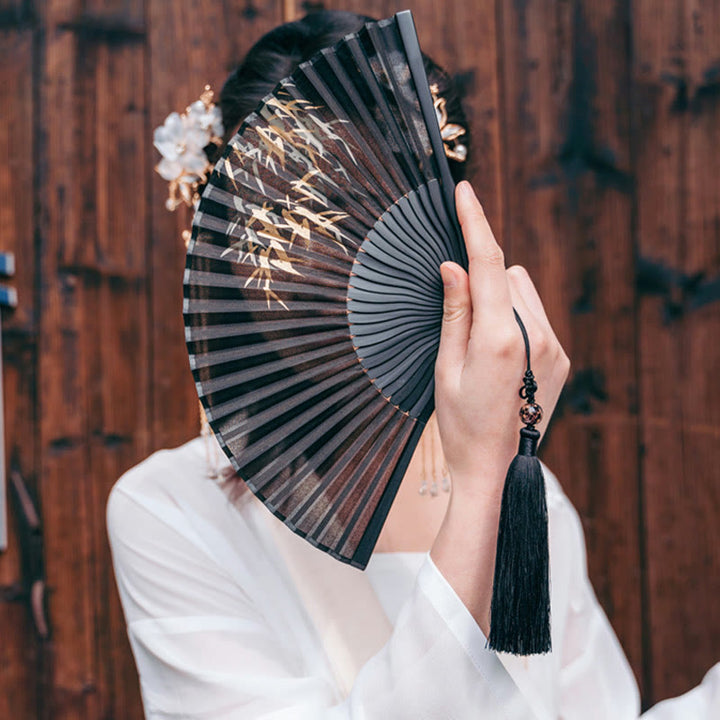 Éventail pliable en bambou à imprimé feuilles de bambou noir avec Buddha Stones