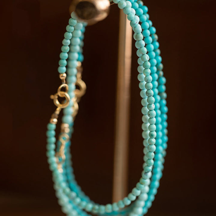 Bracelet de sagesse en cuivre plaqué or 14 carats avec perles ultra-fines turquoise de 2 mm et Buddha Stones
