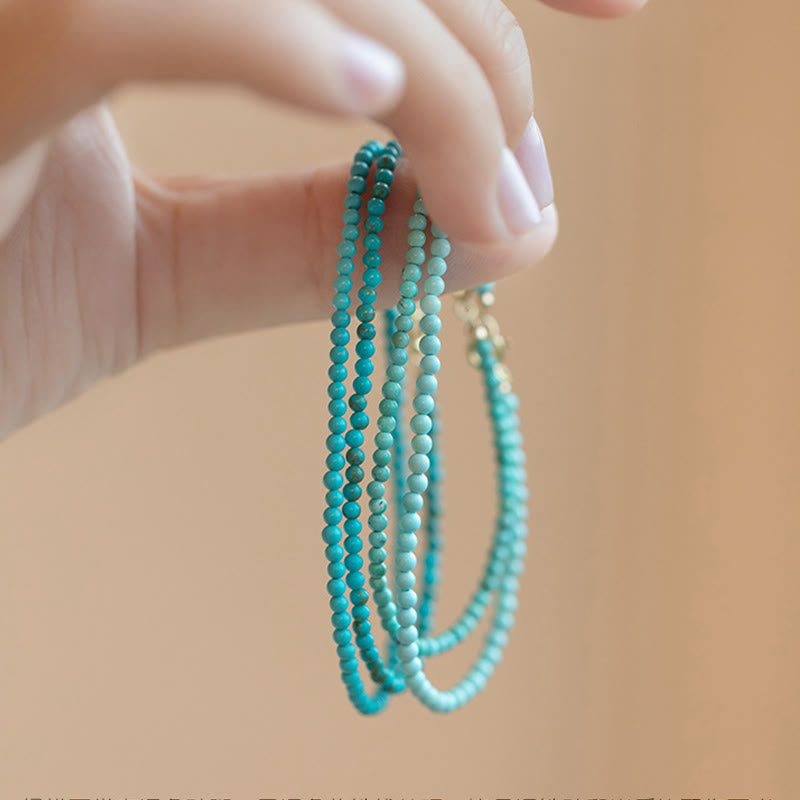 Bracelet de sagesse en cuivre plaqué or 14 carats avec perles ultra-fines turquoise de 2 mm et Buddha Stones
