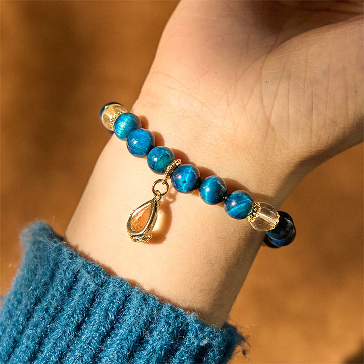 Bracelet de force en forme de goutte d'eau en cristal blanc et œil de tigre bleu Buddha Stones